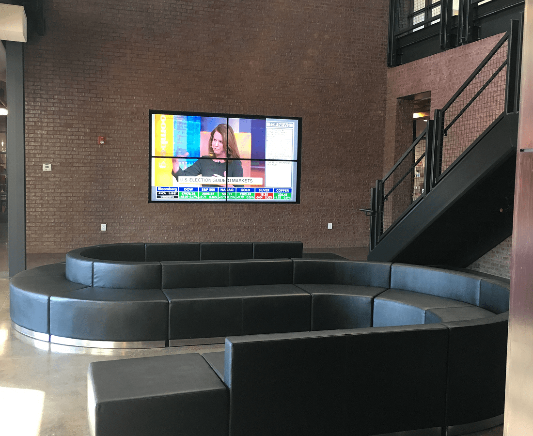 Modern lounge with TV and curved seating.